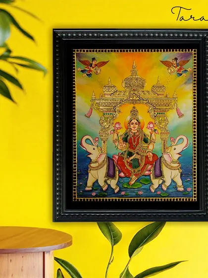 A lifestyle view of our Goddess Lakshmi Tanjore painting, showing how its divine energy can brighten any room. The traditional art form seamlessly complements modern interiors, adding a touch of spiritual elegance.