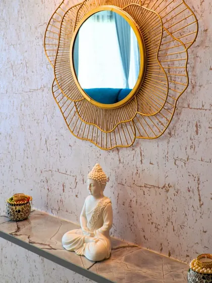A tranquil corner in a client's home, featuring a decorative mirror and a Buddha statue, reflecting the peaceful ambiance they desired.