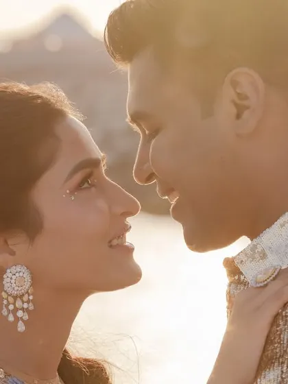 A sun-kissed, close-up portrait of the couple on the deck, their love shining as brightly as the ocean.