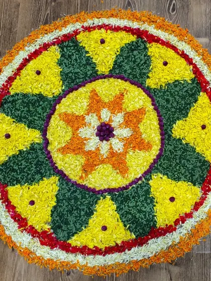 A beautiful Pookalam, or flower rangoli, created for our Onam celebration. The children love participating in making these vibrant designs.