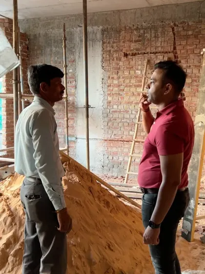A typical day on site involves discussions with my contractors. Here, we are reviewing the next steps for the brickwork and structural support.