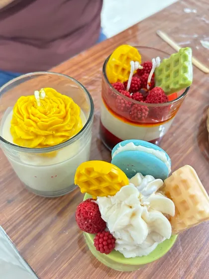 A close-up of the delightful dessert and floral-themed candles that participants can learn to make. We focus on creating visually appealing products, like these yellow rose and berry waffle candles.