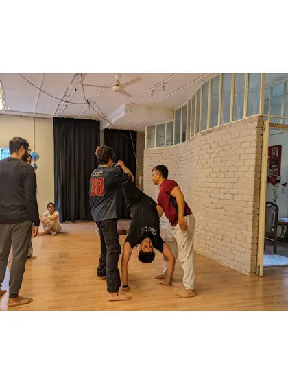 "Trust the process." Students work together to master a challenging acrobatic lift.