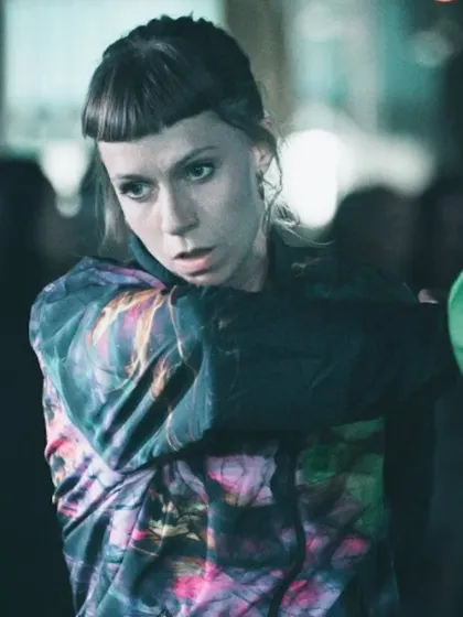 A close-up of a female dancer from the "To Da Bone" crew. Her focused expression conveys the intensity and dedication of the performers.