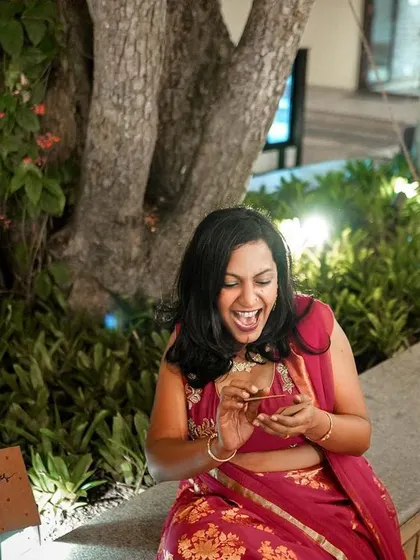 A guest's infectious laughter captured during a fun moment at the reception party.