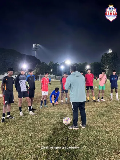 Under the floodlights, our players listen intently to their coach. This is where we transform effort into excellence.