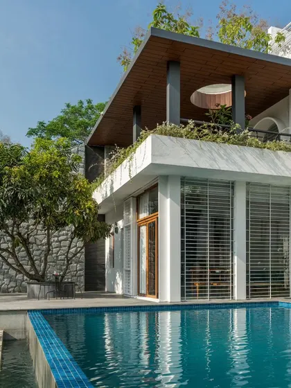 We designed the deck around this beautiful existing mango tree, creating a natural 'katte' or seating area by the pool. It’s a perfect example of building with nature, not against it.