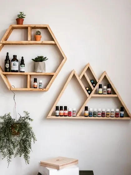 These geometric wooden shelves, in hexagon and mountain shapes, are a stylish way to display essential oils, small plants, or collectibles. They are made from high-quality solid wood and can be arranged to create a unique wall feature.
