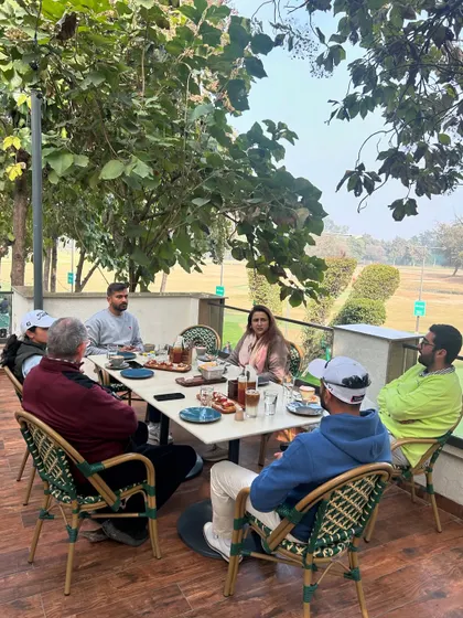 Another angle of a productive and relaxed team meeting at our cafe. The open air and green surroundings help spark creativity and conversation.