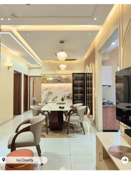 A long shot of a beautiful dining and living area, showing how I create a cohesive design flow between different functional zones in an open-plan home.