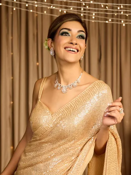 A full view of the vintage French roll, showing how it creates a glamorous and polished look, perfect for this golden sequin saree.