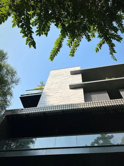An upward view of the facade, showing how the wood-textured concrete planks create a modern yet warm exterior that is built to withstand the elements.