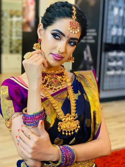 Another angle of the South Indian bridal look, showing how the makeup complements the rich colors of the silk saree and the antique gold jewelry.