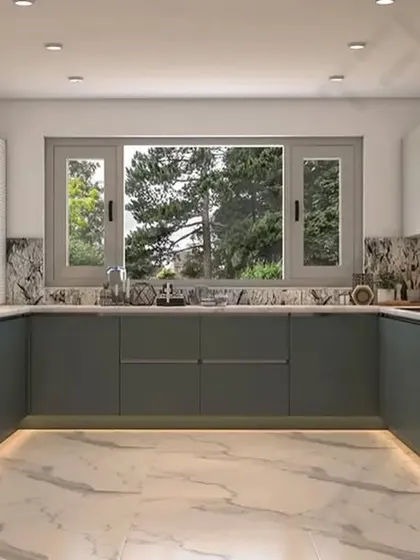 A spacious U-shaped kitchen with matte grey handleless cabinets. The marble-look backsplash and floor-to-ceiling integrated refrigerator give this kitchen a luxurious, high-end feel.