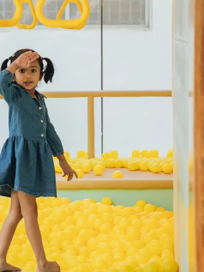 The captain of the ball pit, ready for adventure. Our play areas are designed for safe, energetic fun and endless sensory exploration.