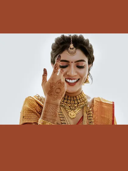 A close-up of the bride's joyful laugh, framed in a warm brown border.