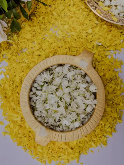 A bowl of fresh jasmine flowers ready for the Haldi ceremony rituals.