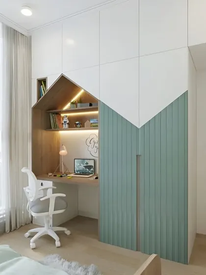 This house-shaped wardrobe and desk unit adds a playful architectural element to a child's room. It provides a defined space for study and keeps the room organized and tidy.