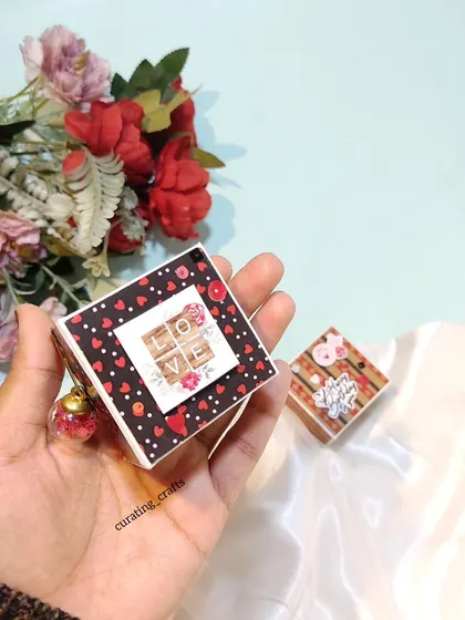 A tiny love-themed scrapbook with a "LOVE" scrabble tile design on the cover.