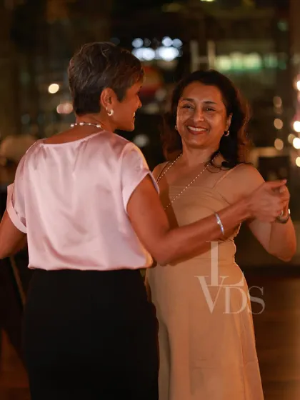 Two women enjoying a dance together, highlighting the inclusive and friendly nature of our community.
