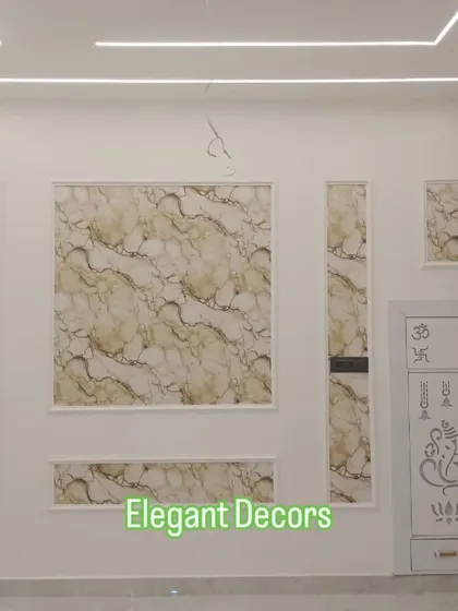 For a classic and elegant look, I use mouldings to frame panels. Here, I've installed different-sized sections of a beige UV marble sheet, each framed in white, next to a custom-designed pooja mandir.