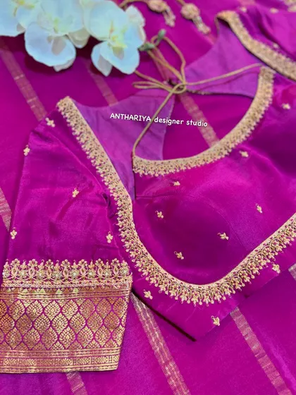 A close-up of the simple and classic design of the magenta blouse.