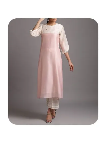 I can also work with modern, layered designs. This kurti features a sheer pink organza layer over a solid white inner piece, creating a contemporary and stylish silhouette.