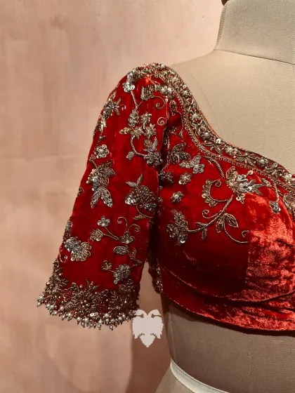 A side view of Jahnavi's blouse, showing the shimmer of the gold and silver sequins on the rich velvet.