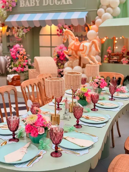 The full tablescape is a feast for the eyes, with layers of color and texture from the flowers, linens, and custom decor elements.