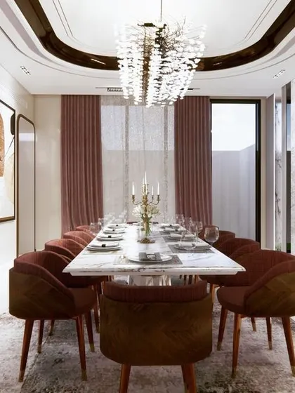 This symmetrical view of the dining room emphasizes its length and grandeur. The elegant doors, rich textures, and sophisticated lighting work together to create a formal and impressive space for entertaining.