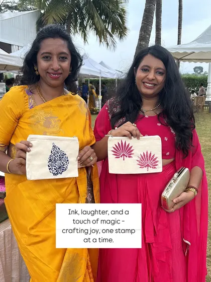 Ink, laughter, and a touch of magic. Two guests at a Nesara wedding showcase the unique pouches they created. Each one is a reflection of their personal style, crafted one stamp at a time.