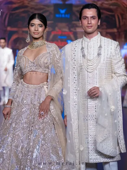 A closer look at the geometric-designed gold sherwani for men. The precise embellishments and modern silhouette define elegance on the runway.