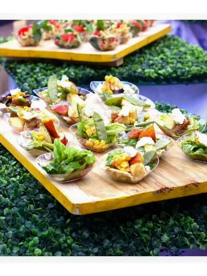 A multi-tiered display of fresh and healthy vegetarian appetizers, perfect for a garden party or daytime event.