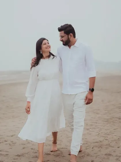 A serene walk along the shore. This photo captures the couple in conversation, creating a natural and peaceful portrait from their Alibag pre-wedding session.