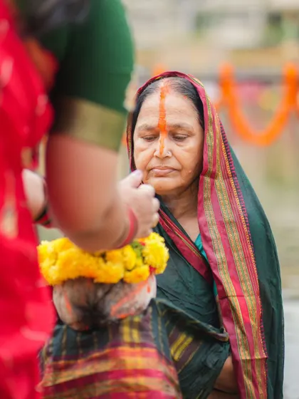 A woman prepares her offering for Chhath Puja. The rituals are performed with great care and devotion, often involving fasting and prayer.