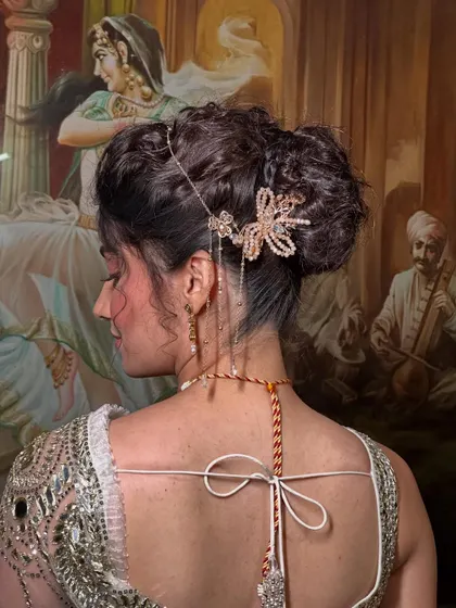 A detailed close-up of the textured bun and the beautiful butterfly hairpiece. I love adding unique accessories to make a hairstyle truly special.