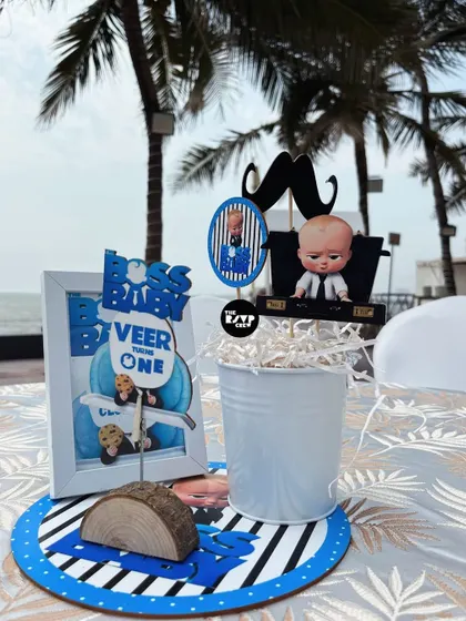 Another Boss Baby centerpiece, this one with a mustache prop and the baby in a briefcase.