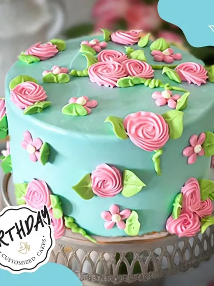 This floral cake brought a garden of delight to Aparna’s birthday in Chattarpur Farms. The pastel blue base is covered in beautifully piped pink roses and green leaves, creating a fresh and vibrant design.