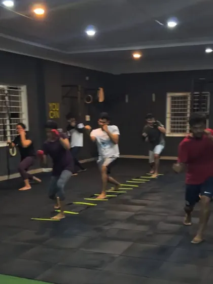 Our members working on footwork drills with an agility ladder while practicing their punches. Boxing is as much about your feet as it is about your hands.