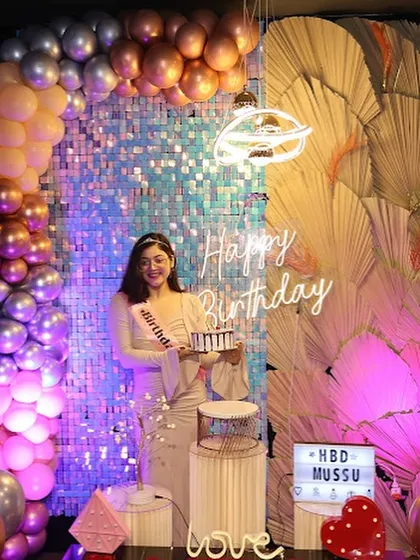 The birthday girl poses against a full backdrop of balloons and a sequin wall, showcasing the grand scale of our decorations. It's a setup designed to wow.