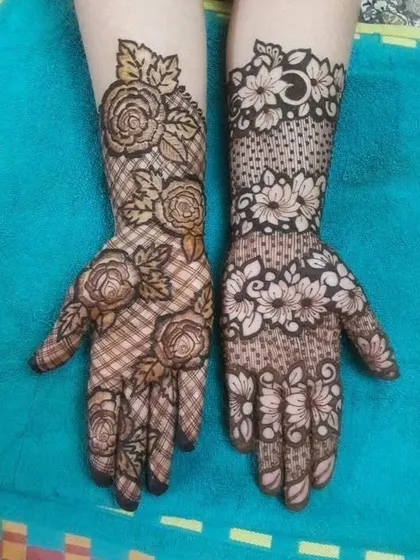 Two hands, two different net designs. One features a classic rose and 'jaal' combo, while the other has a more abstract floral net.