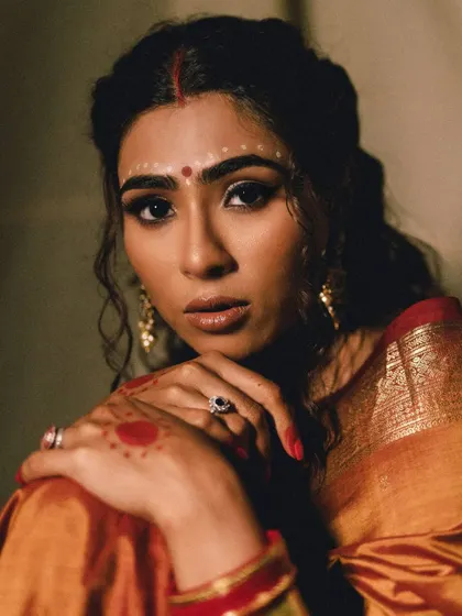 A direct and captivating portrait from the editorial shoot. The model's expressive eyes and the traditional bindi art make for a stunning and powerful image.