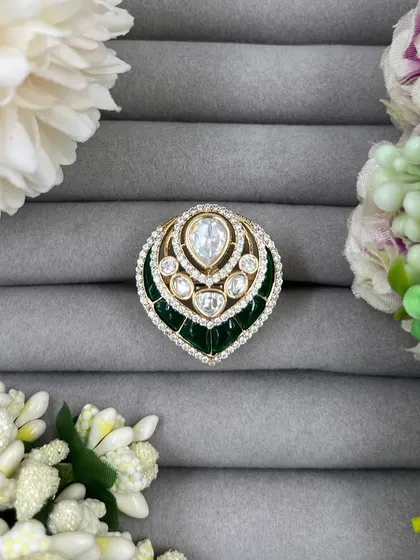 Our leaf-shaped adjustable rings, featuring a large central Moissanite stone surrounded by American Diamonds. These are available in green, red, and pink Meenakari finishes.