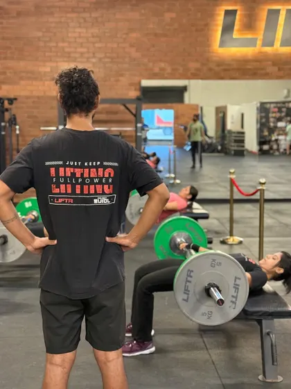 The coach-to-member ratio is key. Here you can see our coaches providing on-the-floor assistance, correcting form during weighted sit-ups and hip thrusts, and ensuring every member gets the attention they need.