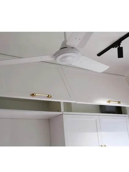 This image shows the functionality of the bi-fold lift-up shutters on the upper cabinets. This mechanism allows for wide, unobstructed access to the cabinet interior, making it easy to store and retrieve items.
