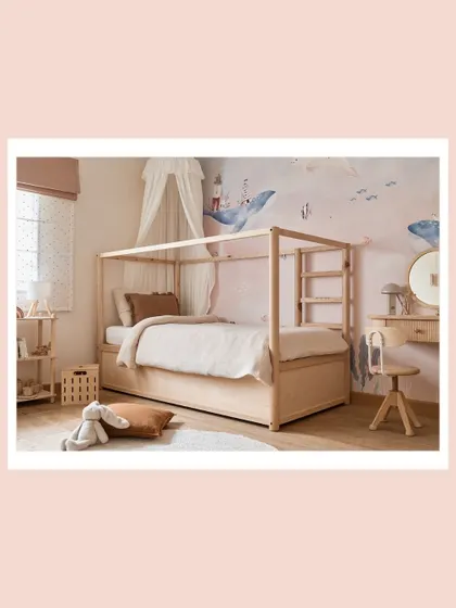 A wide shot of the full room, showing how the canopy bed, dresser, and wallpaper come together to create a cohesive, calming, and functional space for a child.