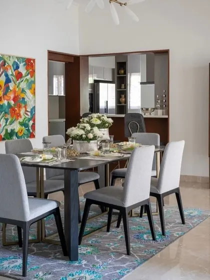A wider view of the Aurora Studio dining room, showing our dining set and a custom glass-fronted crockery cabinet in the background.