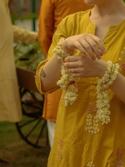 A guest admiring the beautiful jasmine garland she created. These personal, handmade touches become wonderful keepsakes from the celebration.