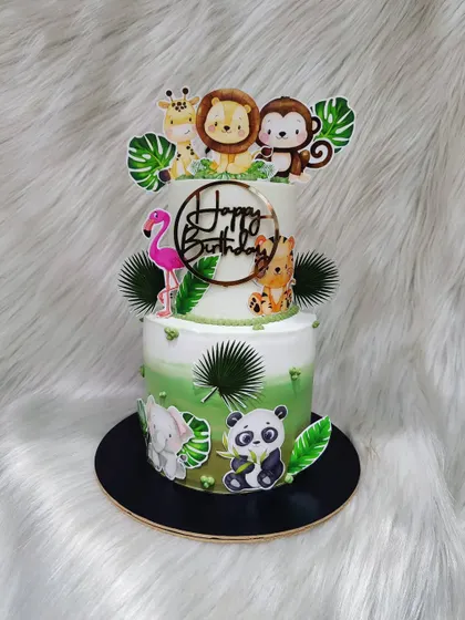 A vibrant two-tier jungle cake packed with animals. From a flamingo and panda to a lion and monkey, it's a party in the wild.