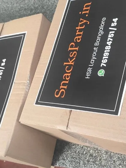 Our brown outer cartons carry the SnacksParty.in label and HSR Layout address, showing another way we pack food for delivery.